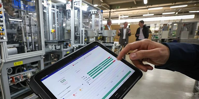 Predictive — a forecast curve and OEE gauge over a factory floor, the Industry 4.0 AI platform